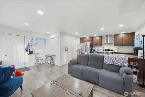 a living room with furniture and kitchen view