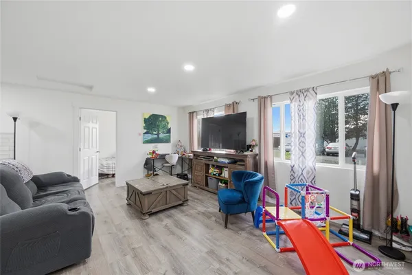 a living room with furniture and a flat screen tv