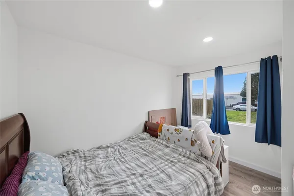 a bedroom with a bed and sliding door
