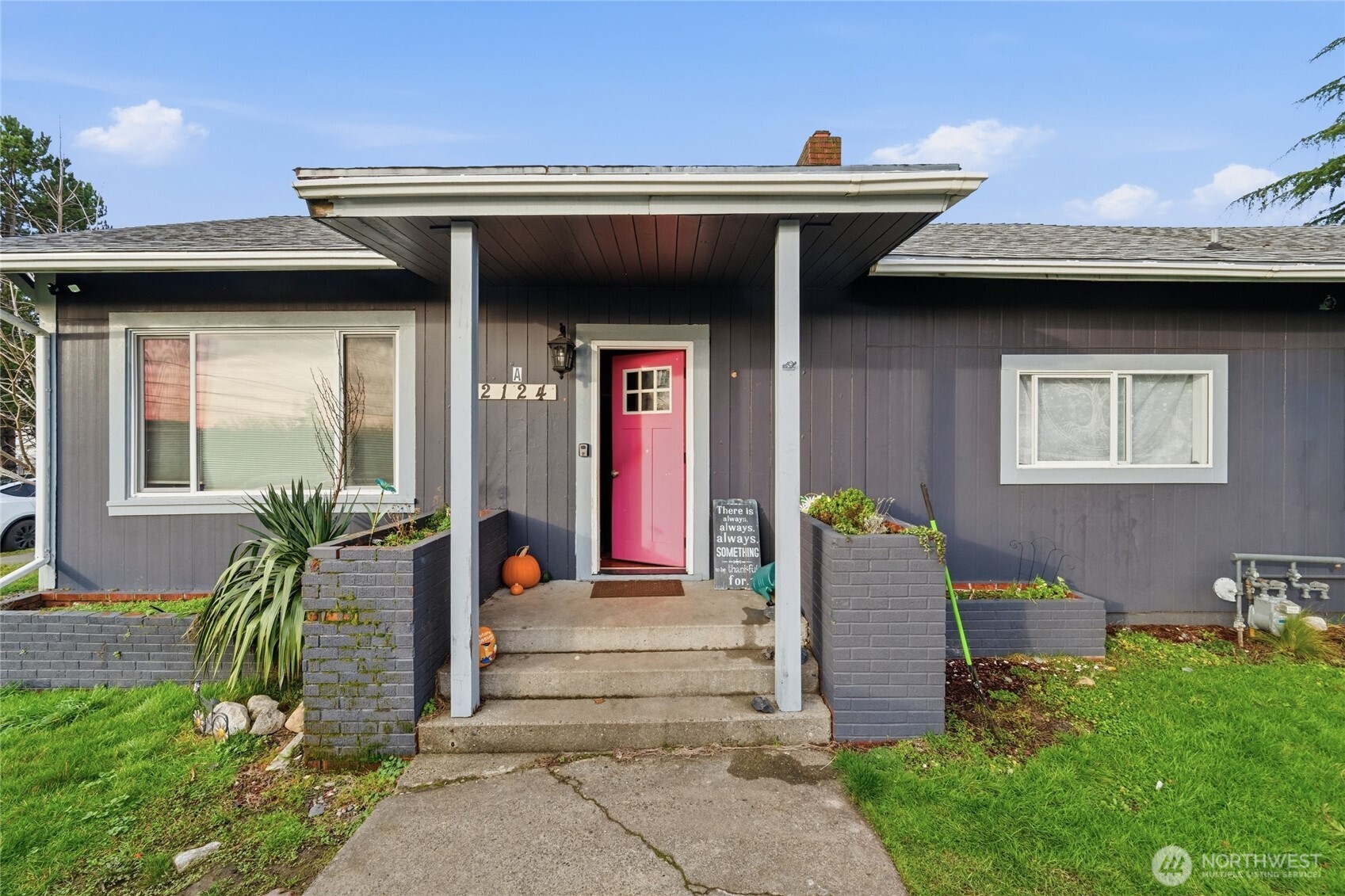 2124 Woburn Street Bellingham, WA 98229 - Photo 9 of 40 a view of a house with large windows and plants