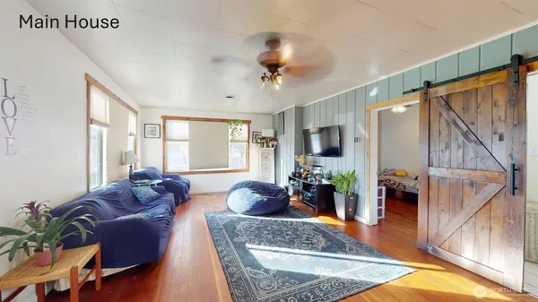 a living room with furniture potted plant and a window