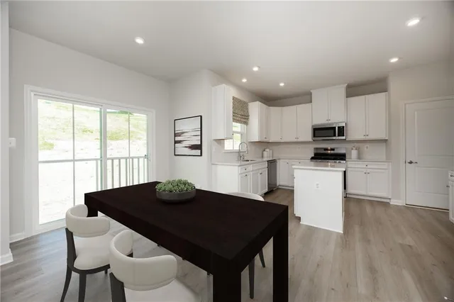a kitchen with a table and chairs in it