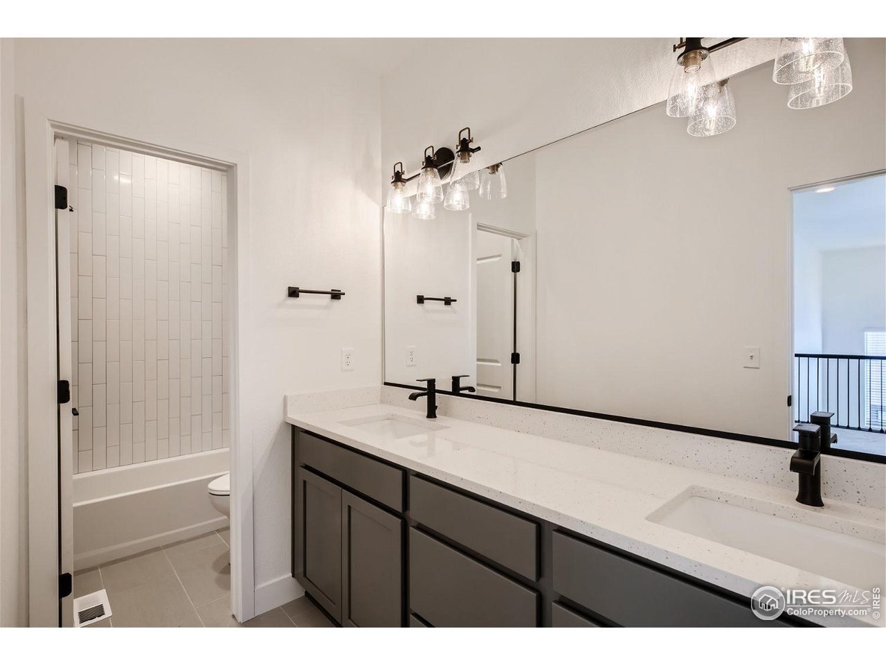 335 Boxwood Drive Windsor, CO 80550 - Photo 12 of 23 a bathroom with a sink and a mirror