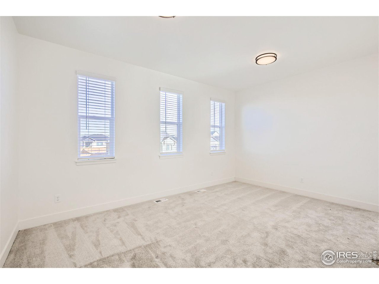 335 Boxwood Drive Windsor, CO 80550 - Photo 14 of 23 an empty room with windows