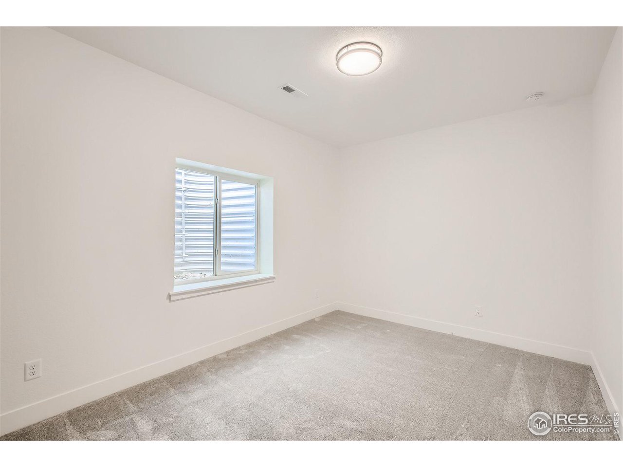 335 Boxwood Drive Windsor, CO 80550 - Photo 17 of 23 an empty room with a window