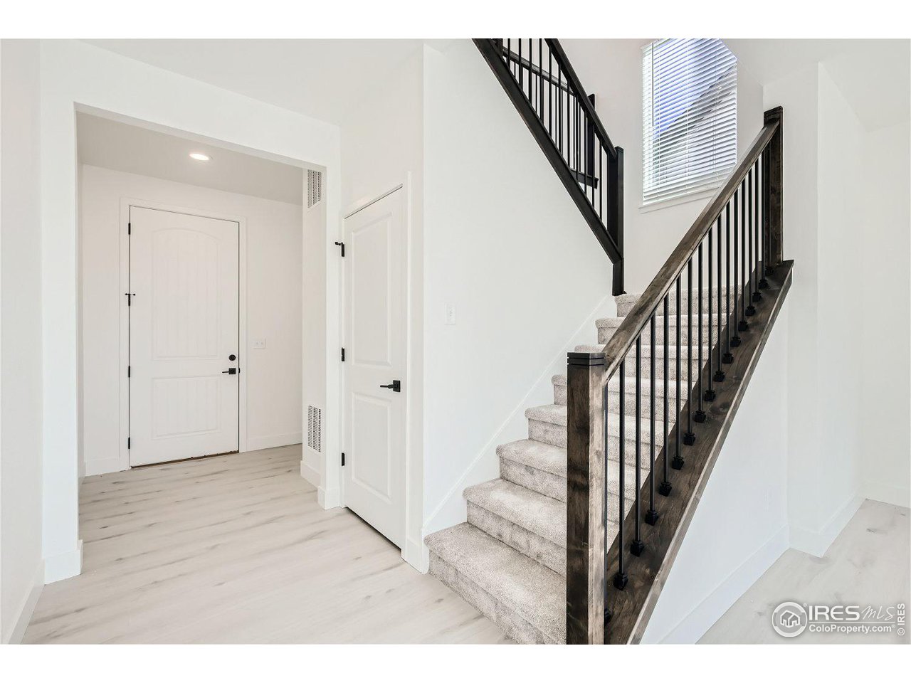 335 Boxwood Drive Windsor, CO 80550 - Photo 4 of 23 a view of an entryway with wooden floor