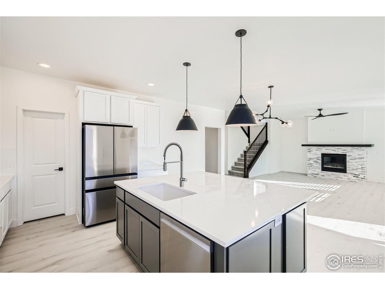 335 Boxwood Drive Windsor, CO 80550 - Photo 5 of 23 a kitchen with a sink a refrigerator and a stove