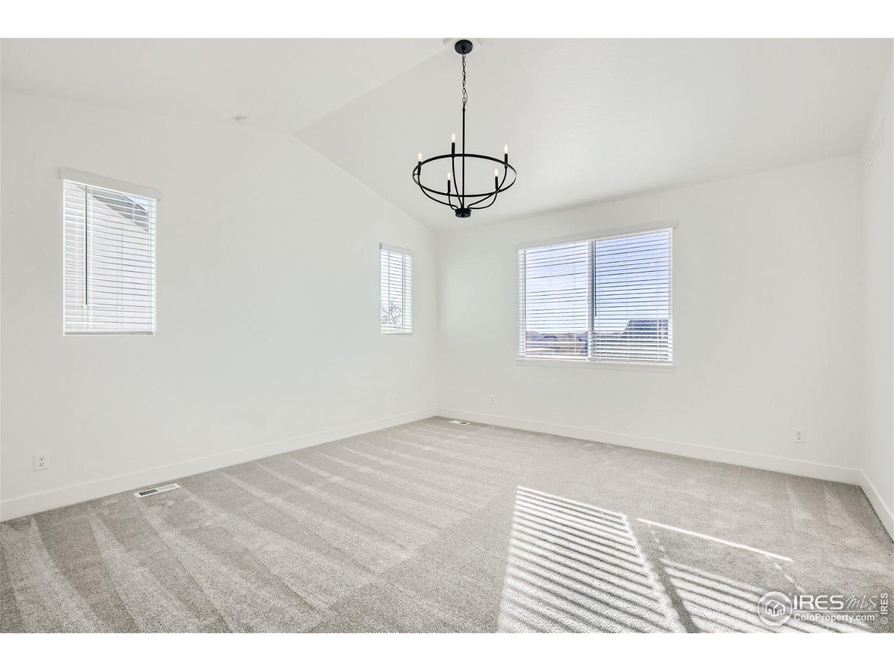 335 Boxwood Drive Windsor, CO 80550 - Photo 7 of 23 a view of an empty room with windows and ceiling fan
