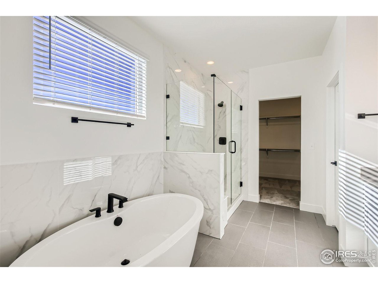 335 Boxwood Drive Windsor, CO 80550 - Photo 8 of 23 a bathroom with a tub shower sink and mirror