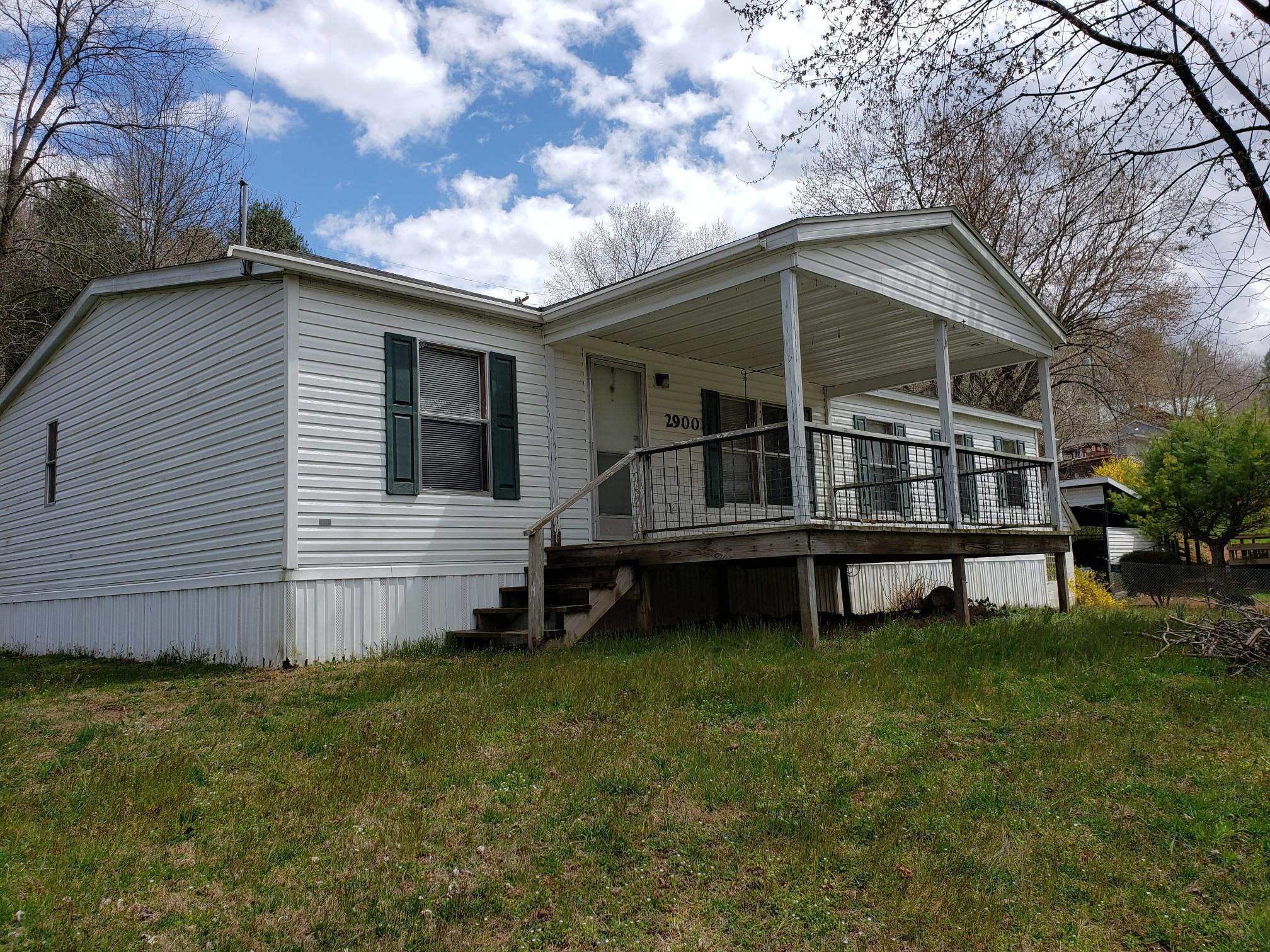 a view of house with backyard and garden