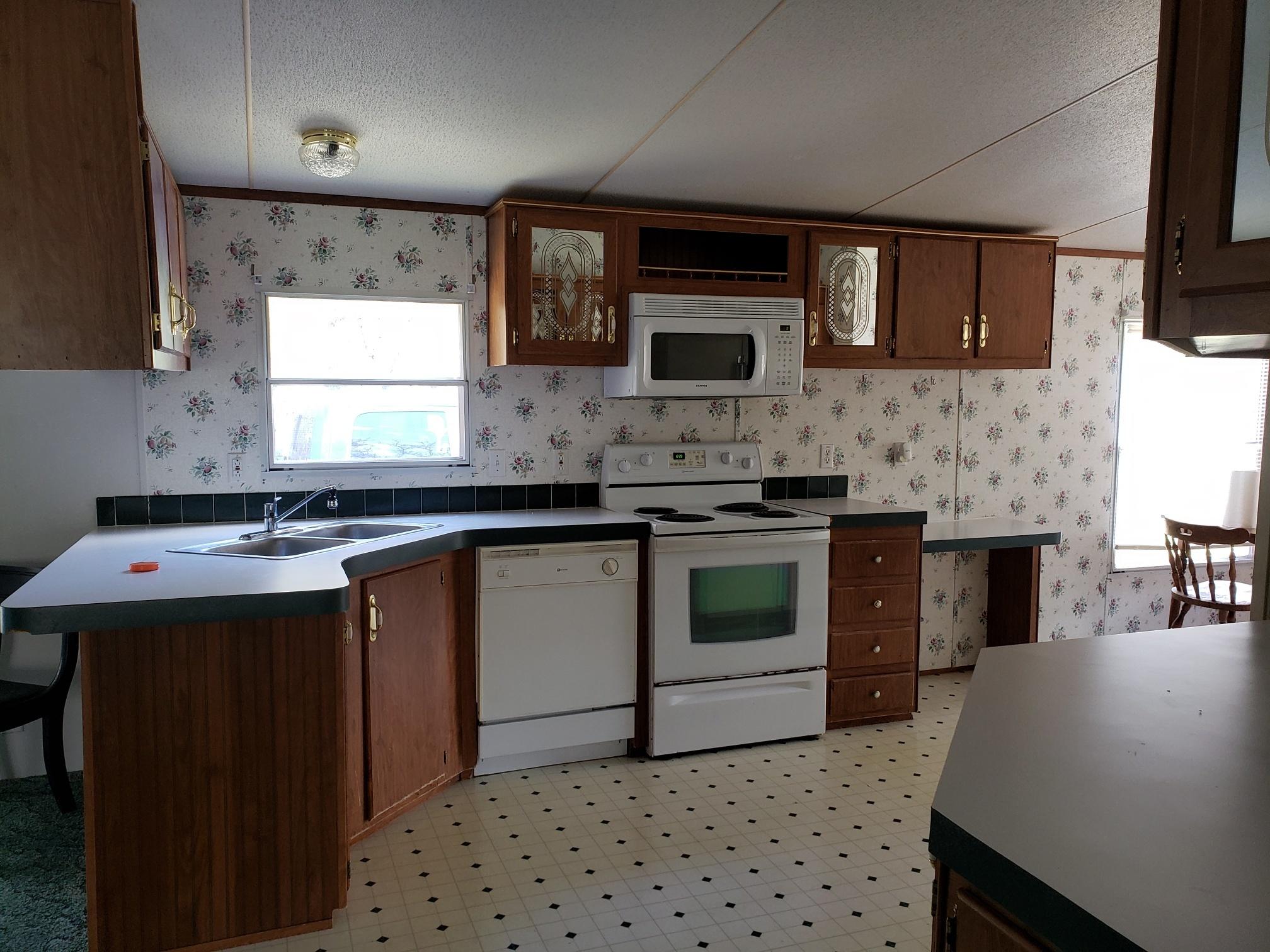 2900 Alleghany Spring Road Shawsville, VA 24162 - Photo 14 of 19 a kitchen with stainless steel appliances a sink stove top oven and microwave