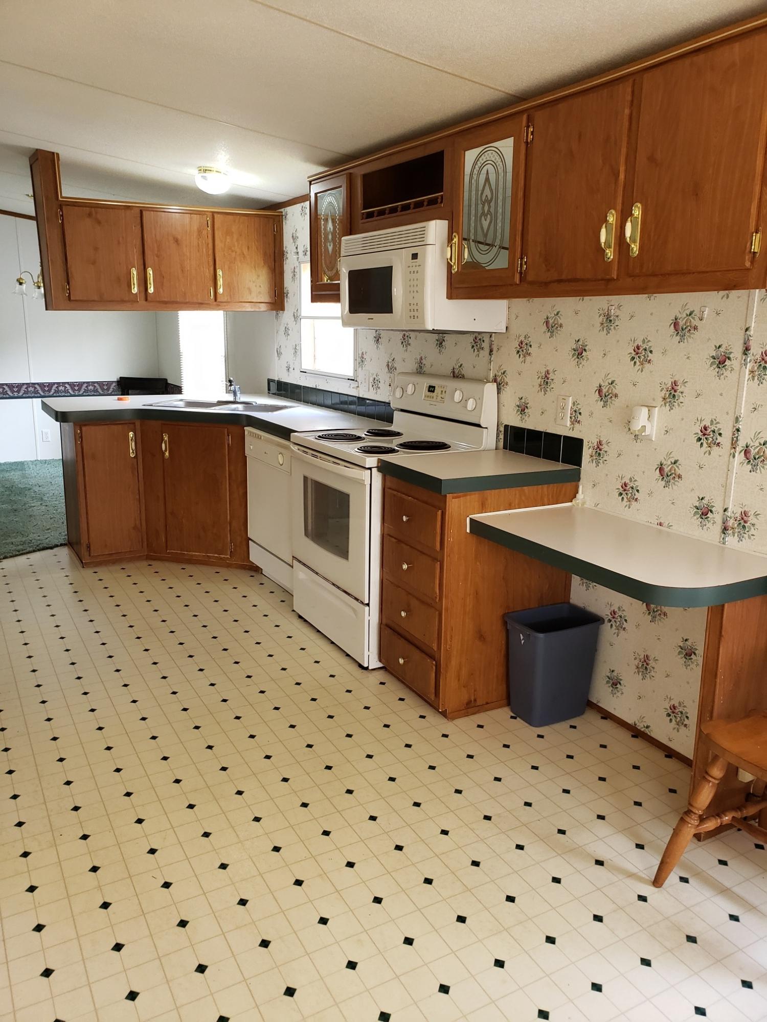 2900 Alleghany Spring Road Shawsville, VA 24162 - Photo 15 of 19 a kitchen with a stove a sink and a refrigerator