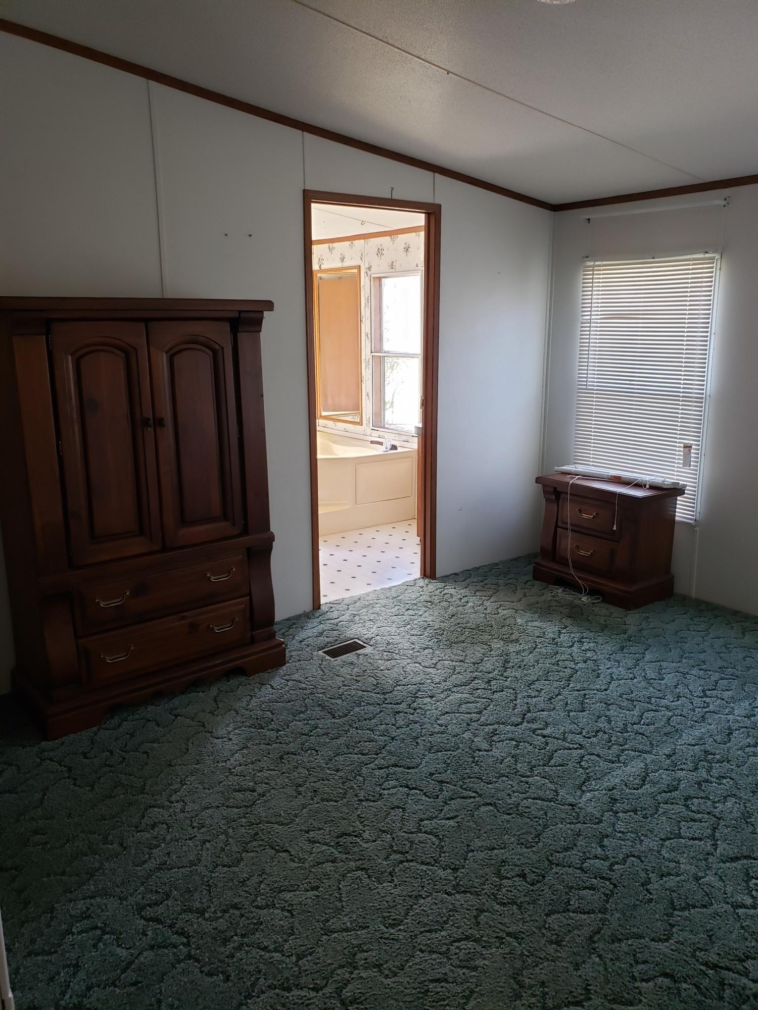 2900 Alleghany Spring Road Shawsville, VA 24162 - Photo 9 of 19 an empty room with wooden floor and windows