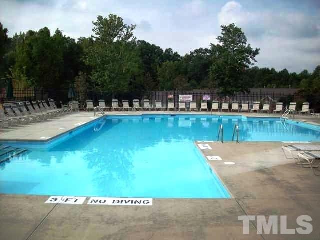 5306 Echo Ridge Road Raleigh, NC 27612 - Photo 3 of 3 a view of a swimming pool with a yard and trees