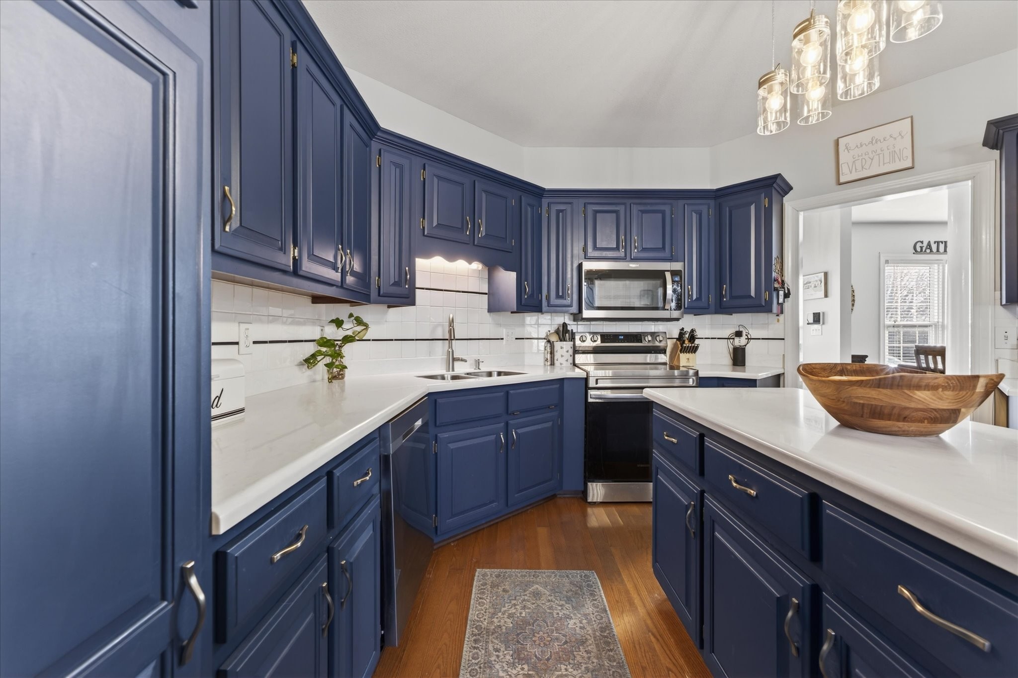 200 Cheshire Road Clarksville, TN 37043 - Photo 14 of 33 a kitchen with a sink a stove a microwave and wooden cabinets