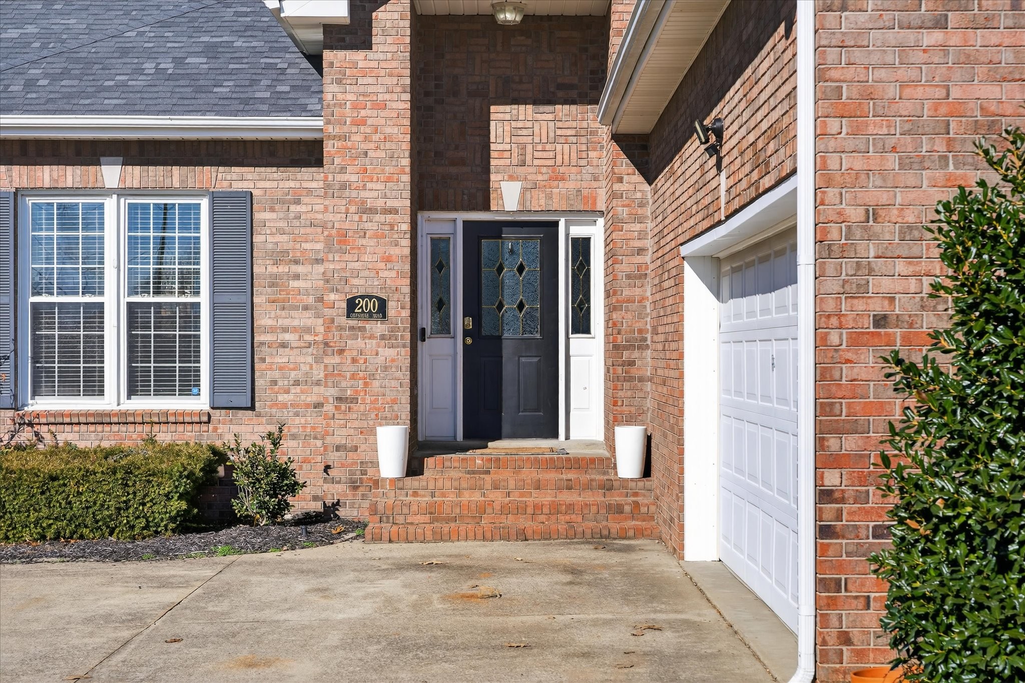 200 Cheshire Road Clarksville, TN 37043 - Photo 5 of 33 a view of a brick house with potted plants