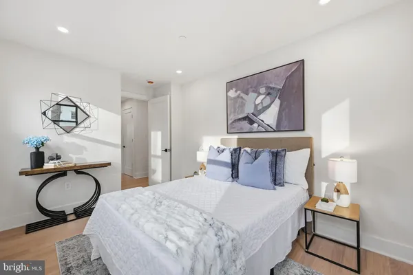 a bedroom with a bed and the bathroom