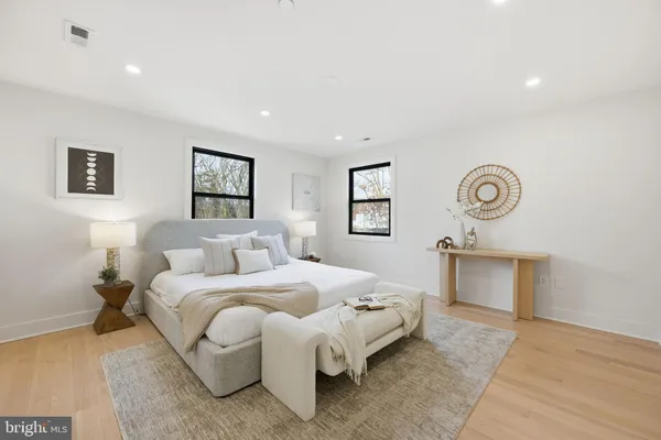 a bedroom with a bed and a night stand