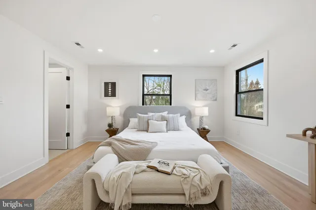 a bedroom with a large bed and a painting