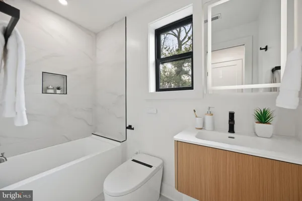 a bathroom with a toilet a sink and bathtub