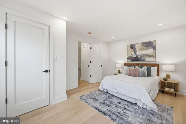 a bedroom with a large bed and a chandelier