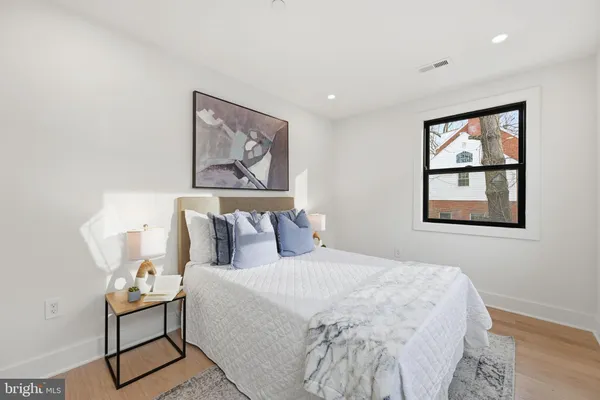 a bedroom with a bed and a painting on the wall