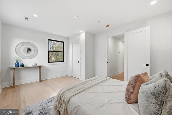 a bedroom with a bed and painting on the wall