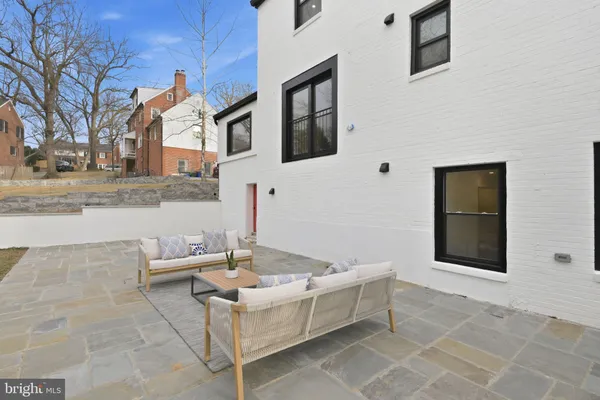 a view of a patio with couches and table and chairs