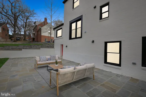 a view of a patio with couches and a table and chairs