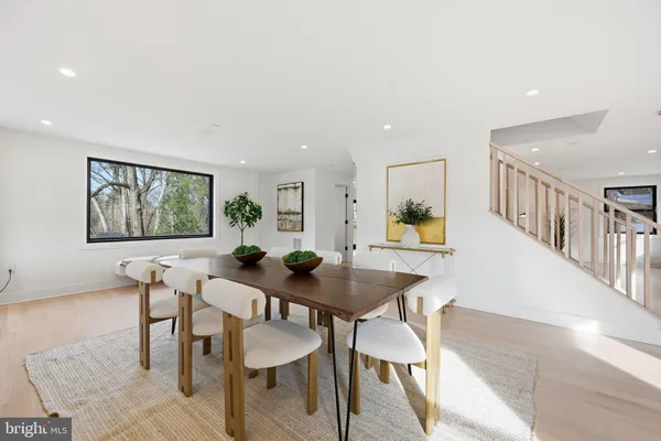 a view of a dining room with furniture and a potted plant