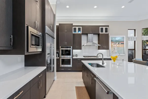 a kitchen with a sink a stove and cabinets