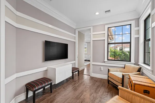 a bedroom with a bed couch and a large window