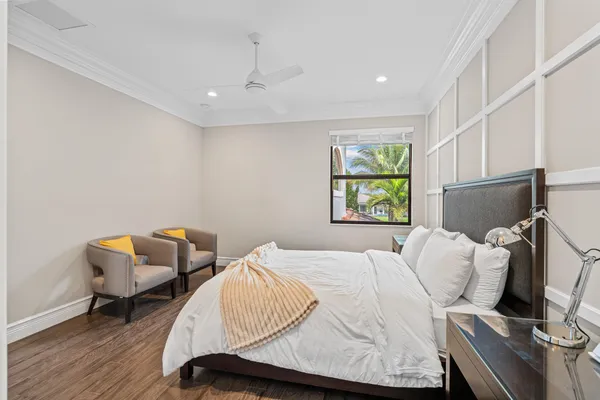 a spacious bedroom with a bed and a flat screen tv