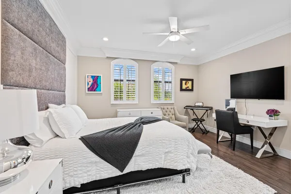 a balcony with couple of chairs and a fire pit