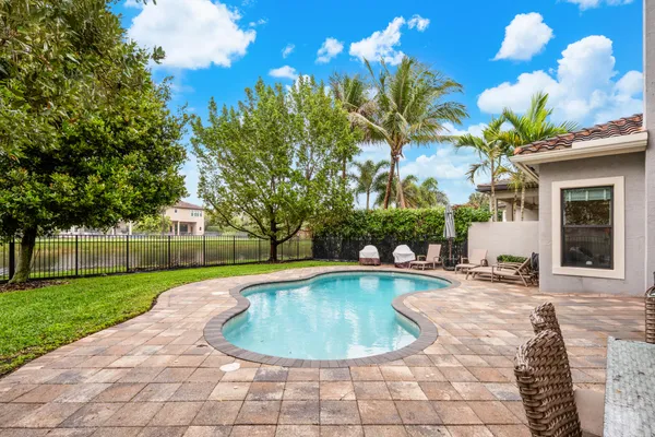 a view of a house with swimming pool and sitting area