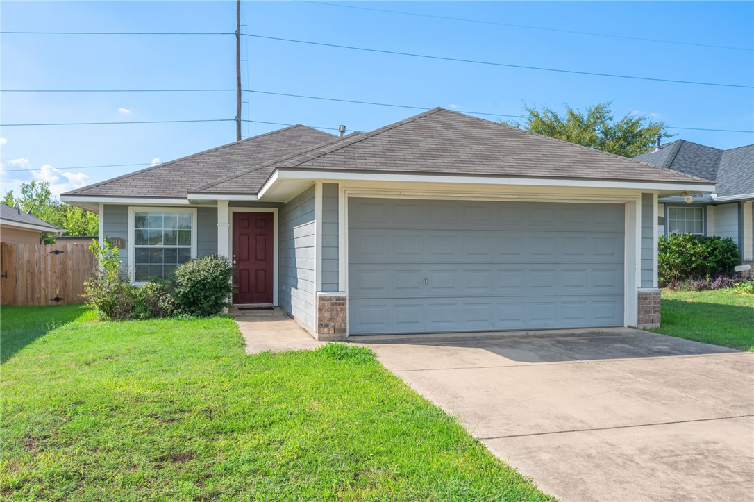 1114 Cottage Grove Circle Bryan, TX 77801 - Photo 1 of 1 Ranch-style house with a shingled roof, concrete driveway, a garage, and brick siding