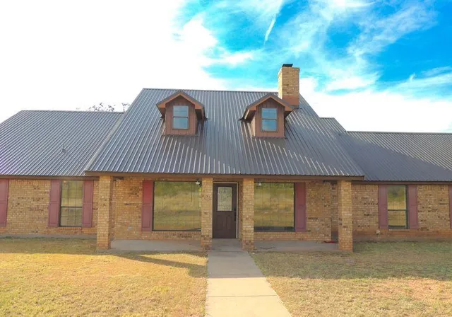 a front view of a house with a large window