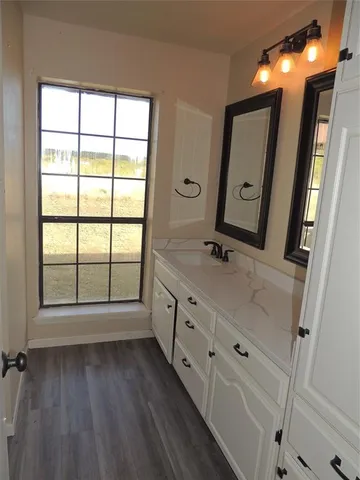 a bathroom with a double vanity sink and a mirror