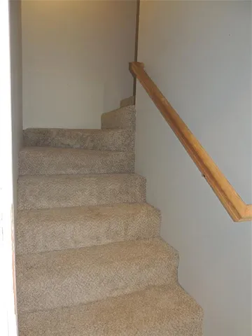 a view of staircase with white walls