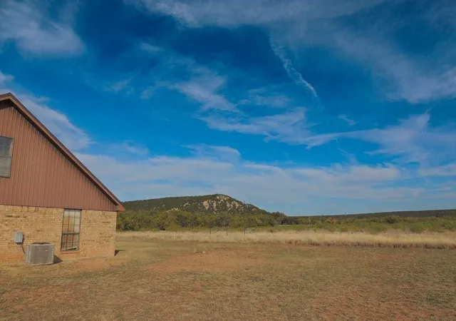 a view of house with a yard