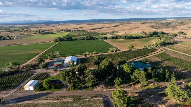 an aerial view of a city with lots of residential buildings ocean and mountain view in back