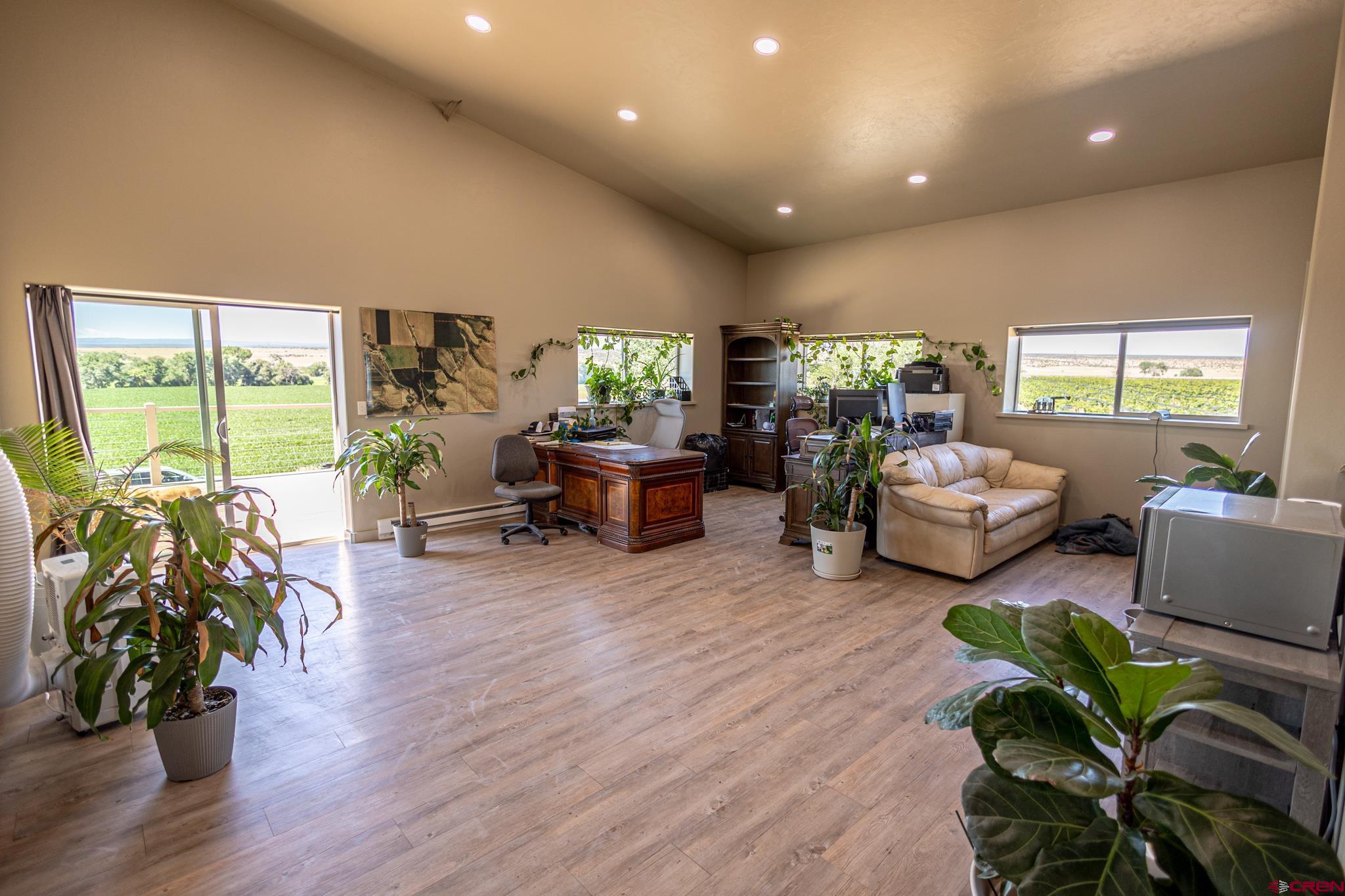 53582 Falcon Road Olathe, CO 81425 - Photo 24 of 42 a living room with furniture floor to ceiling window and wooden floor