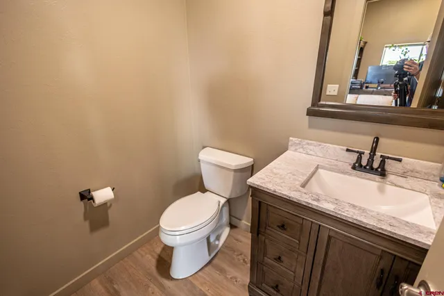 a bathroom with a granite countertop toilet and sink