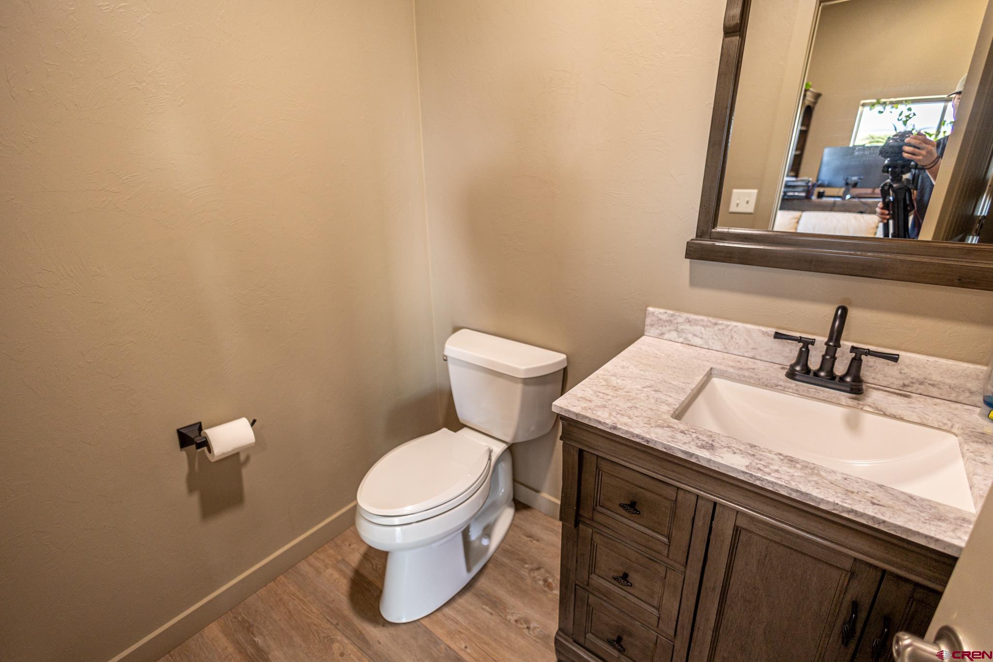 53582 Falcon Road Olathe, CO 81425 - Photo 25 of 42 a bathroom with a granite countertop toilet and sink