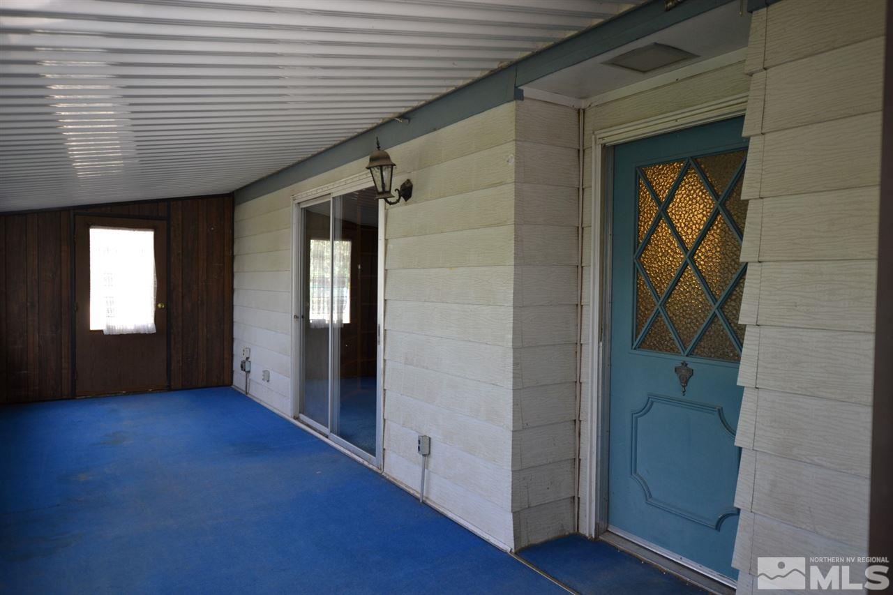 16055 Rhyolite Circle Reno, NV 89521 - Photo 2 of 23 a view of an empty room with wooden floor and a window