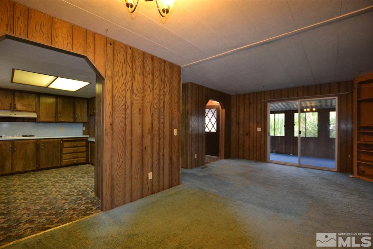 16055 Rhyolite Circle Reno, NV 89521 - Photo 3 of 23 a view of a hallway with an entryway and livingroom with furniture