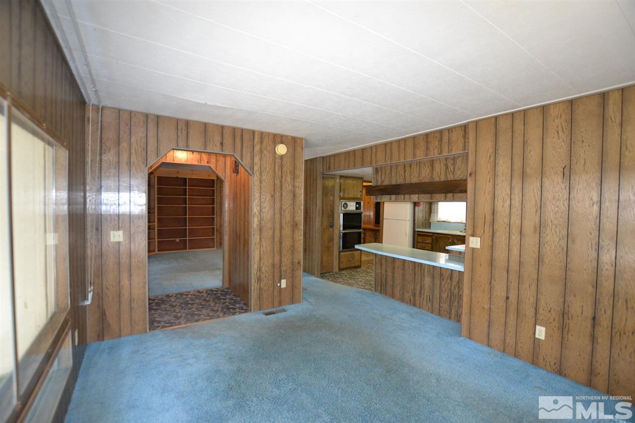16055 Rhyolite Circle Reno, NV 89521 - Photo 4 of 23 a view of a hallway with wooden shelves