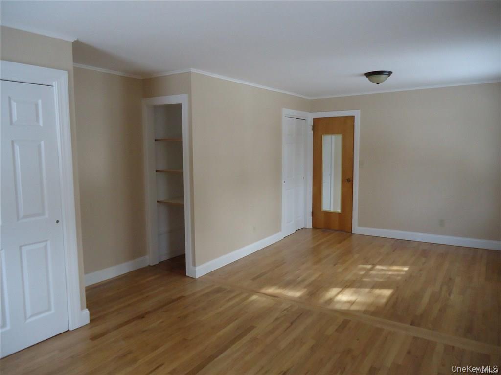 56-58 Still Road Monroe, NY 10950 - Photo 9 of 18 Spare room featuring baseboards, light wood finished floors, and crown molding