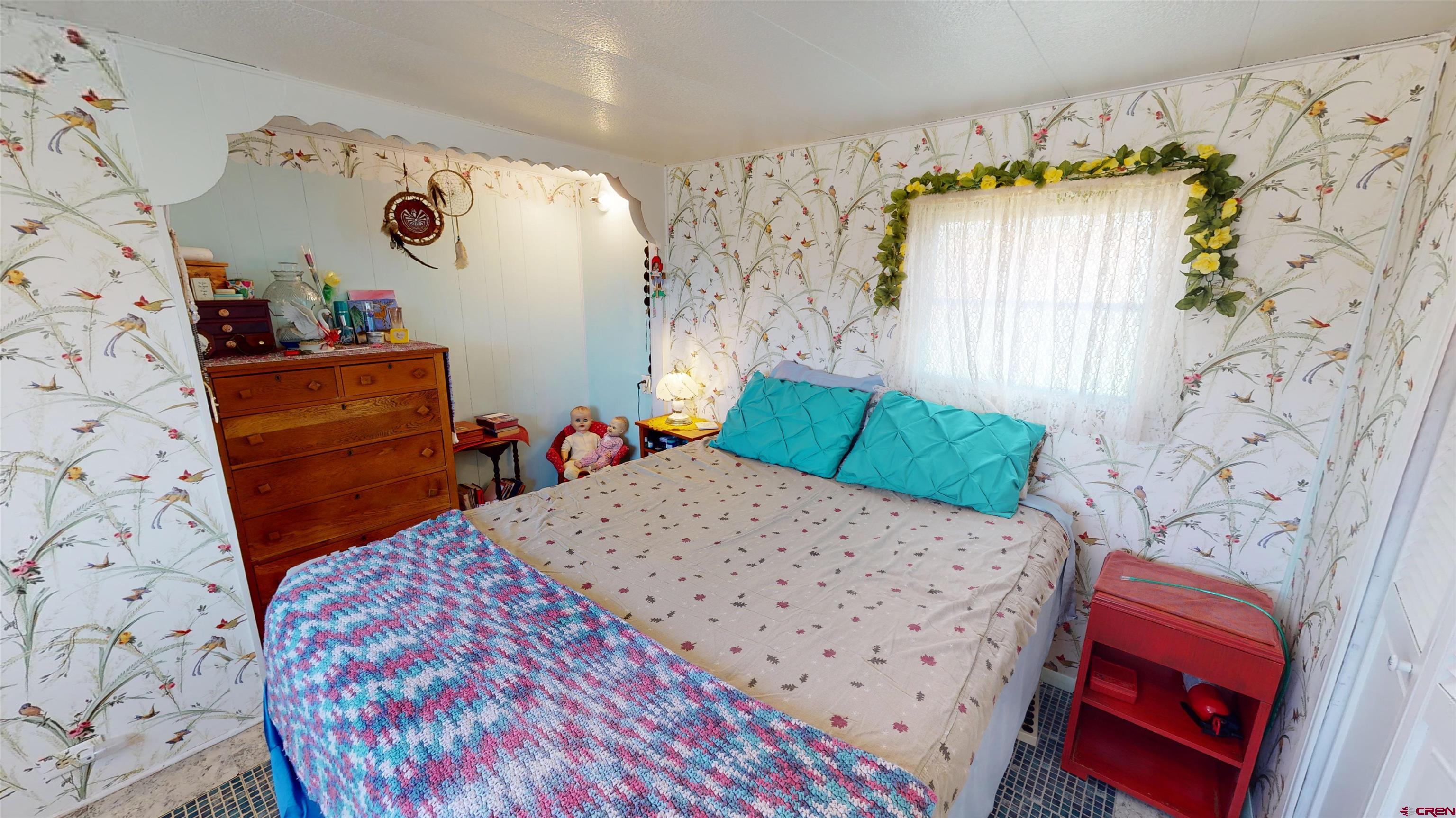 337 County Road 4018 Navajo Dam, CO 87419 - Photo 11 of 20 a bed room with a bed and a chair