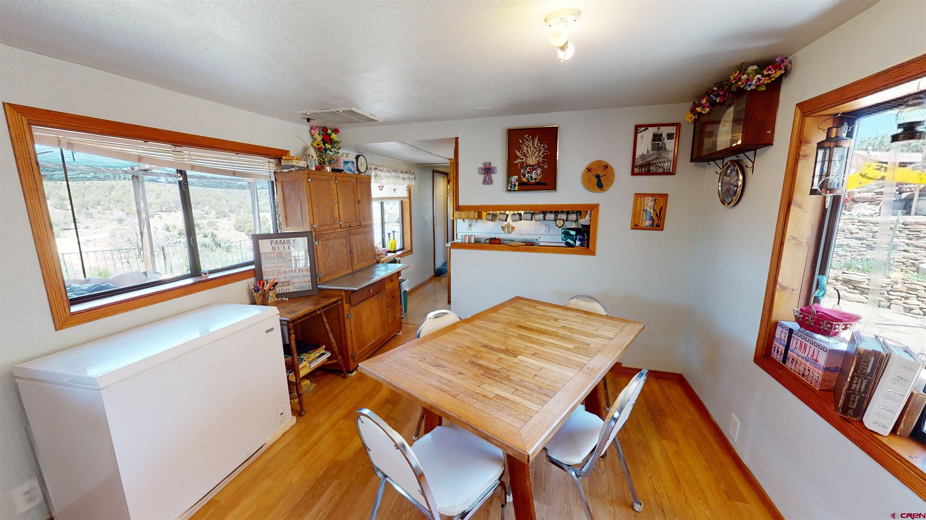 337 County Road 4018 Navajo Dam, CO 87419 - Photo 12 of 20 a view of a dining room with furniture window and wooden floor